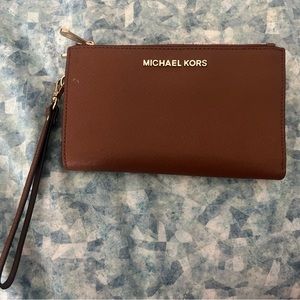 Michael Kors saffiano leather luggage color wallet and cell phone holder.